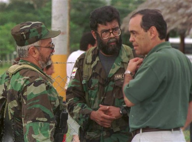 Colombia's Peace Commissioner Camilo Gomez, right, talks to Revolutionary Armed Forces of Colombia (FARC) leaders Alfonso Cano, center, and Raul Reyes, during peace talks in Los Pozos, in southern Colombia. According to Colombian military authorities, Cano, the top FARC commander, was killed in a military operation on Friday.